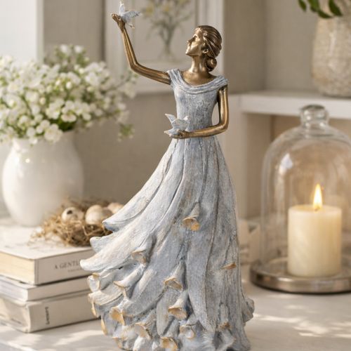 Product Figurine of a woman with a bird. Artfully designed decorative sculpture for timeless design. 41cm